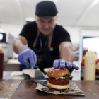 Un cuiner presenta una hamburguesa elaborada amb proteïna vegetal.