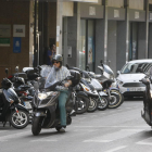 Dos motoristas y varios vehículos aparcados en Lleida.