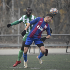 Un jugador del Torà remata de cap davant de la pressió rival.