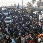 Palestinos desplazados internos caminan por la carretera Al Rashid en el centro de Gaza mientras regresan del sur al norte de la Franja de Gaza.