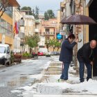 Alcarràs. Dos vecinos de Alcarràs retirando el granizo acumulado delante de su casa.