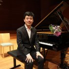 Yuanfan Yang, guanyador del Concurs Internacional de Piano Ricard Viñes, posa amb el piano amb què va guanyar ahir el certamen. - AMADO FORROLLA