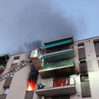 Els Bombers intenten apagar el foc en un bloc de Sarrià de Ter. - ACN/BOMBERS