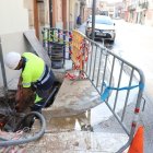 Un operari de l’empresa Agbar reparant ahir la rebentada al carrer Raval del Carme. - MAGDALENA ALTISENT