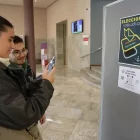 Una jove fa una foto del QR per votar en els comicis, ahir. - AMADO FORROLLA