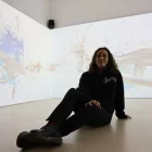 La creadora visual Alba G.Corral posant amb la seua obra, projectada a la planta baixa del Morera. - AMADO FORROLLA