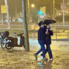 Una parella camina sota la pluja a l’altura d’Illa Diagonal, a Barcelona. - GERARD ESCAICH/ACN