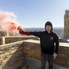 Un dels participants encén una bengala al Castell del Rei. - JORDI ECHEVARRIA