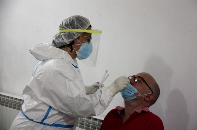 Un profesional sanitario haciendo una PCR a una persona en el marco del cribado masivo llevado a cabo en el Centro Cívico el Passeig de la Seu d'Urgell.