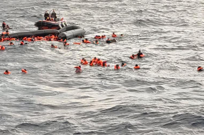 Los migrantes en el agua tras hundirse su embarcación.