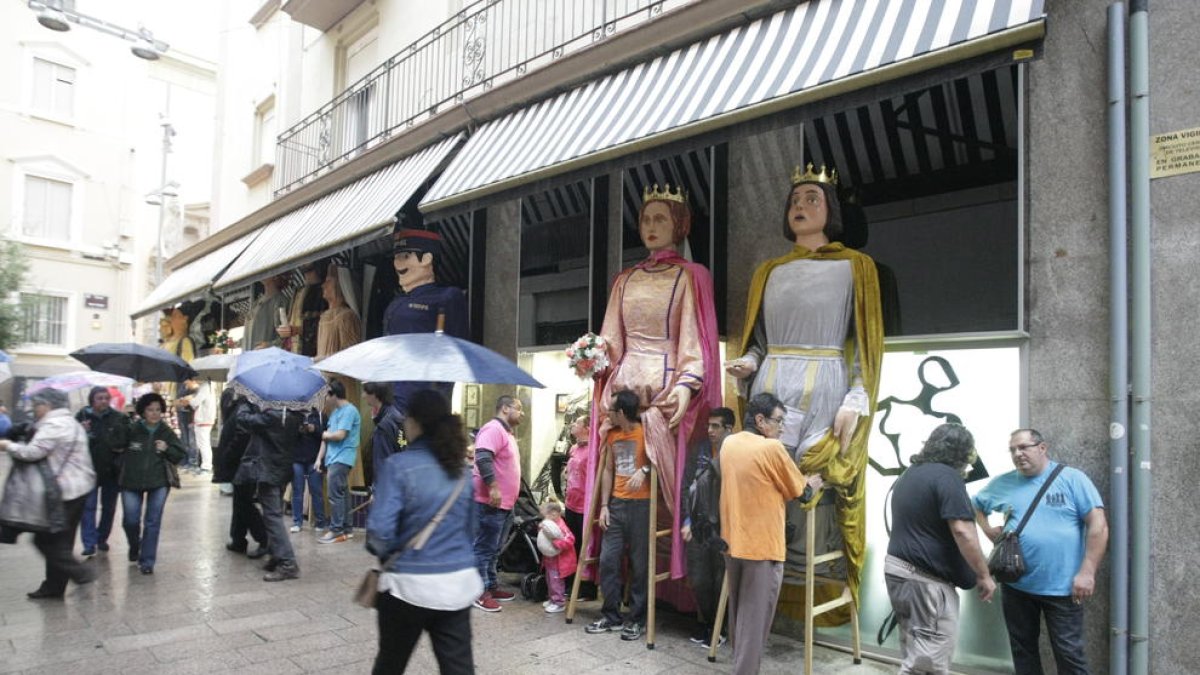 La pluja va obligar a protegir els gegants sota el tendal d’una botiga de l’Eix.