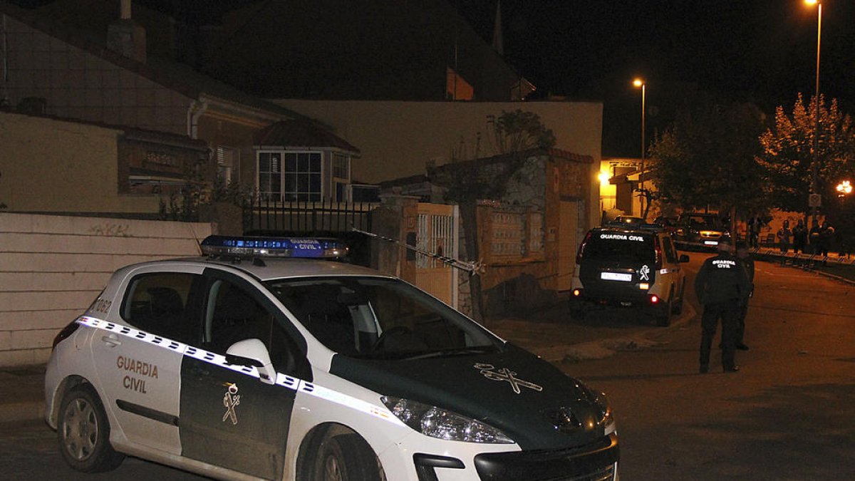 Un cotxe de la Guàrdia Civil al costat de l’habitatge on es van trobar els cadàvers a Lleó.
