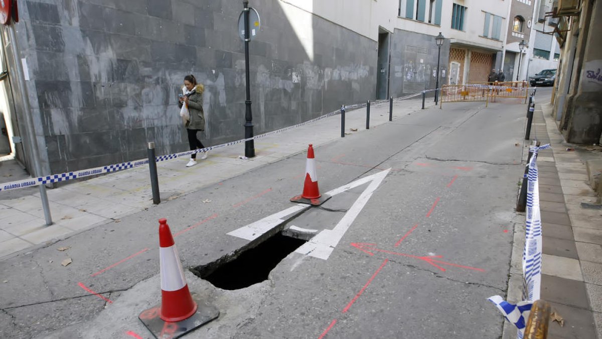 Imagen de obras de reparación por la tarde en la zona y, arriba, el socavón que apareció por la mañana.