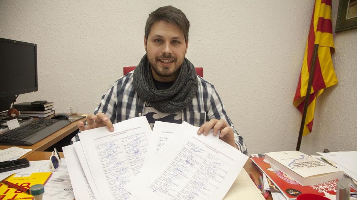 Eduard Piera muestra las firmas que han recogido.