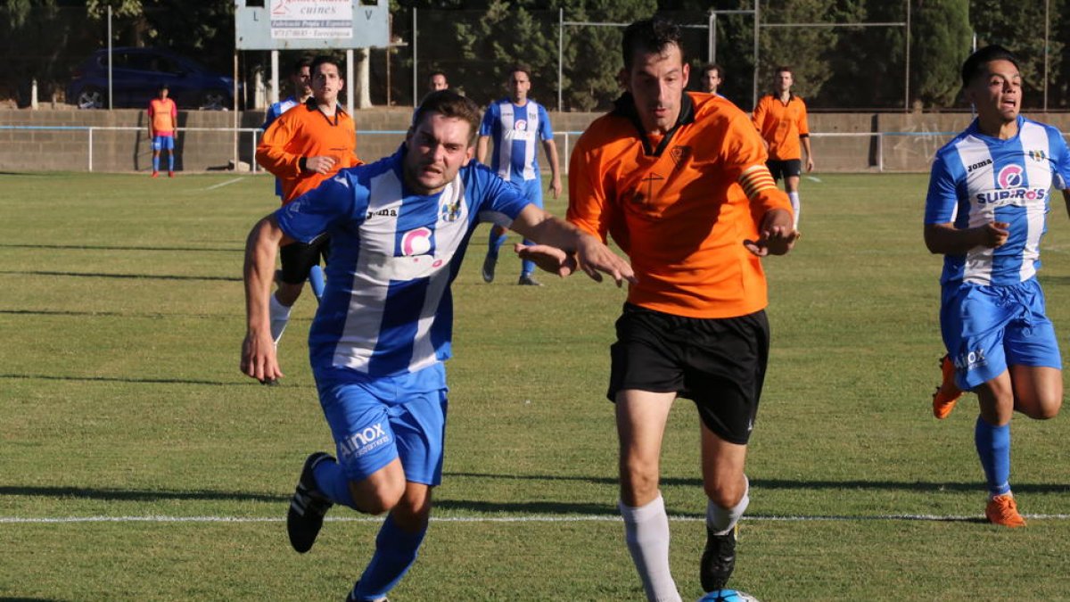 Un jugador del Torregrossa pugna per la pilota amb el capità de la Seu.