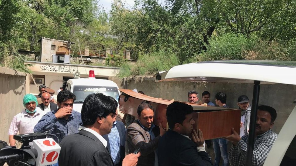 Diverses persones traslladen el cadàver d’un dels periodistes morts ahir a Kabul.