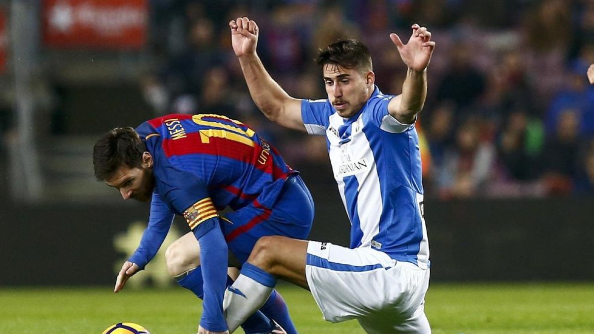 Leo Messi es entrado con fuerza por un defensa del Leganés.