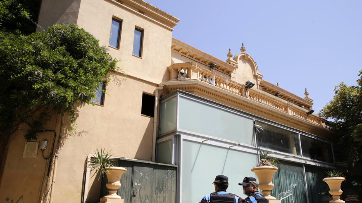 Dos agentes de la Guardia Urbana inspeccionan el agujero por el que entraron unos jóvenes en el River.