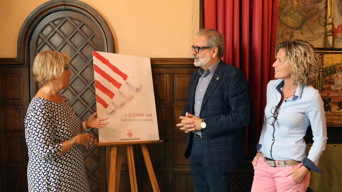 Montse Parra, Fèlix Larrosa i Montse Mínguez, davant del cartell.