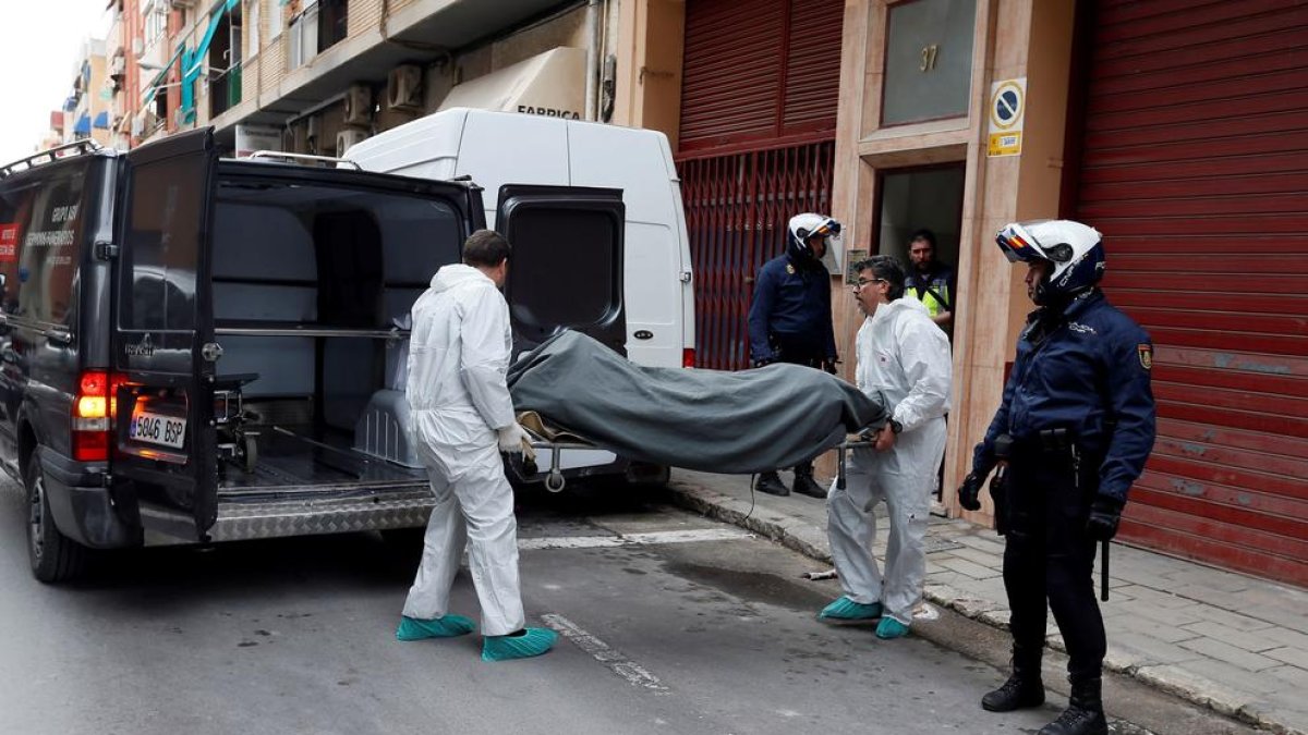 Operaris traslladen el cadàver del jove de 19 anys.