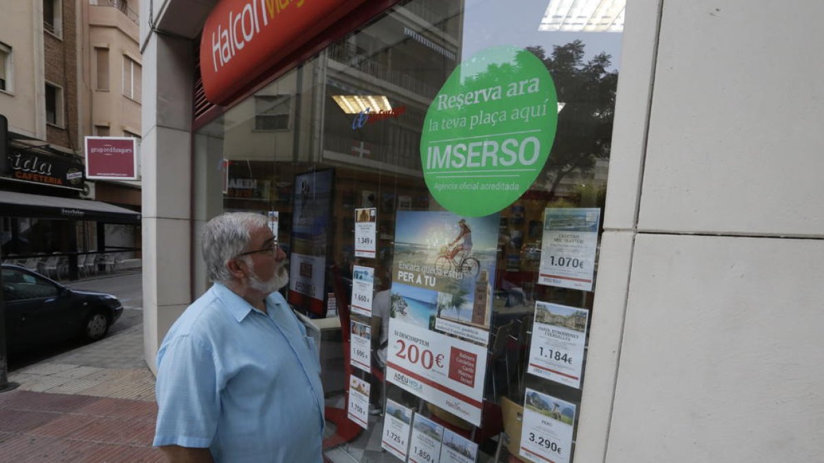 Imagen de ayer de una agencia de viajes de Rovira Rour, con el anuncio de reserva de plazas.