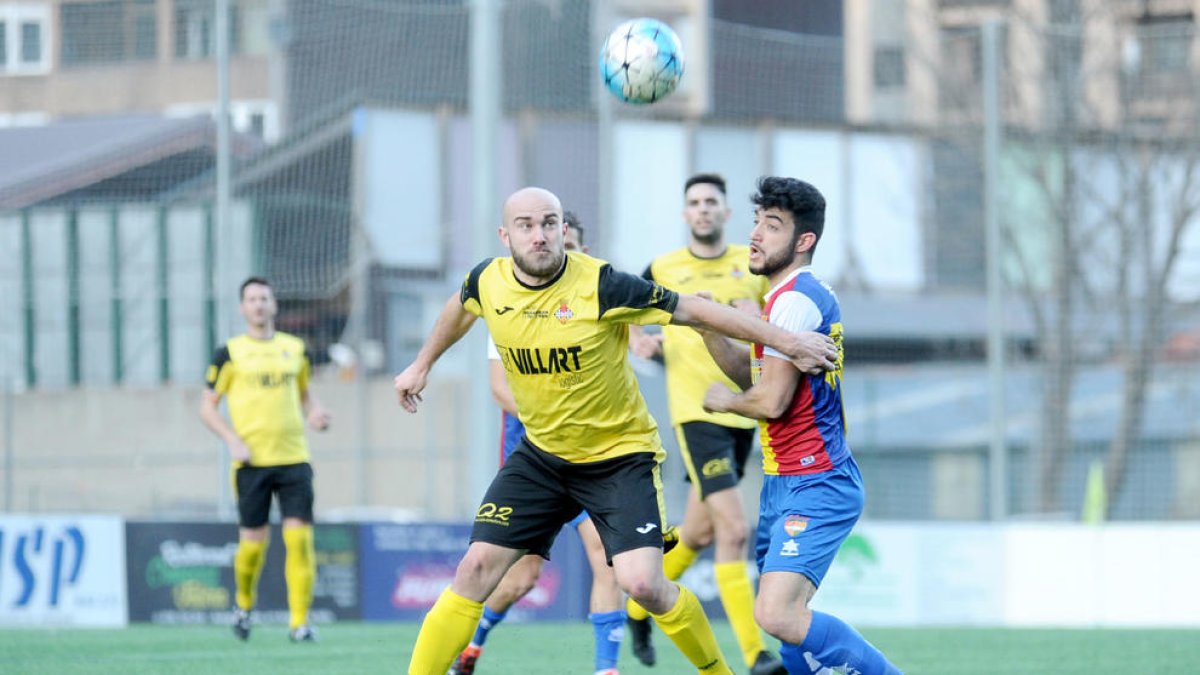Un jugador del Balaguer se anticipa a otro del Andorra en la lucha por un balón dividido.