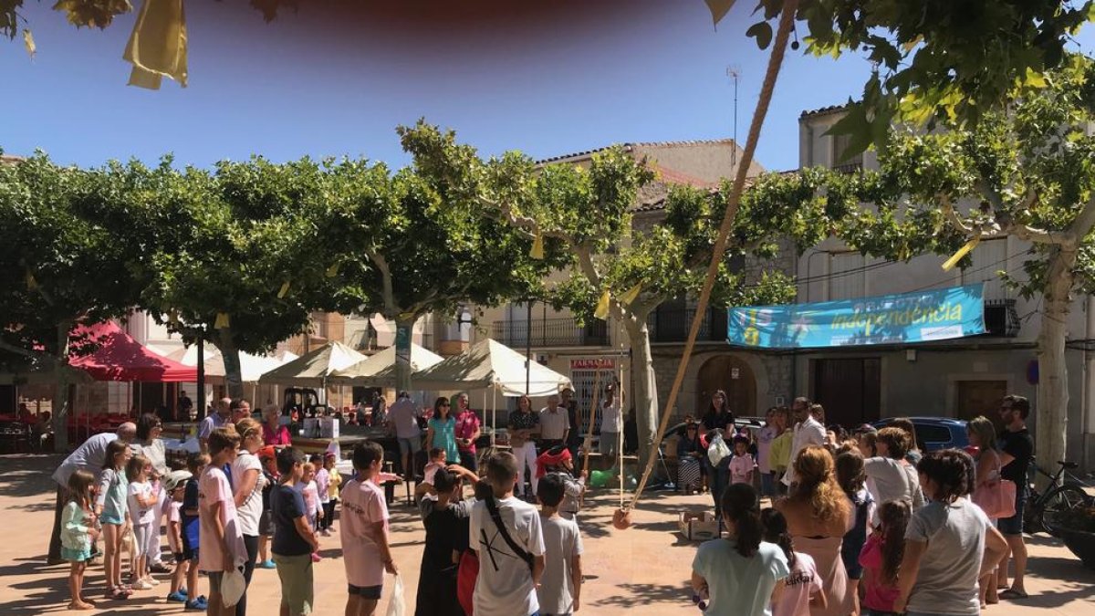 Los niños de Castelldans se lo pasaron en grande con las cucañas. A la derecha, el periodista Lluís Caelles abriendo las fiestas de Tremp.