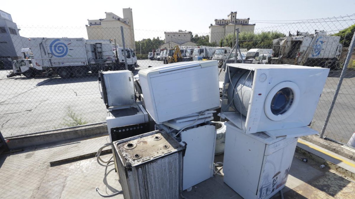Un trabajador de la ‘deixalleria’ de Pardinyes, junto a un contenedor con aparatos electrónicos.