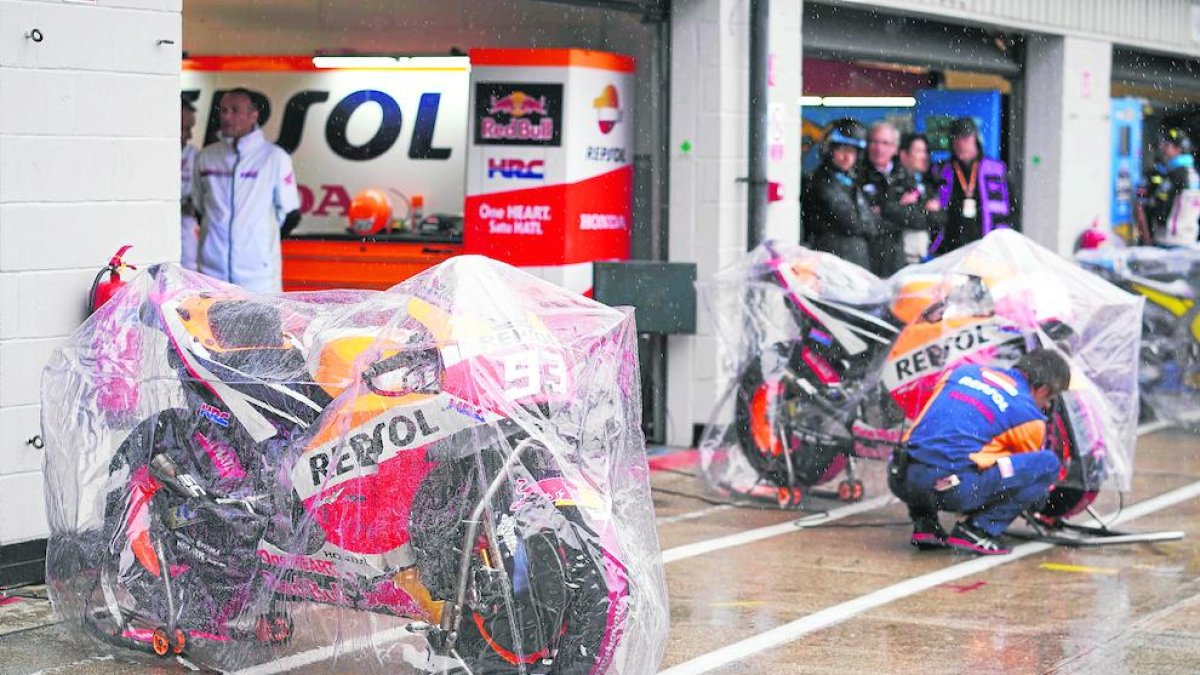 Les motos de Marc Màrquez i Dani Pedrosa, protegides de la pluja que va caure sobre Silverstone.