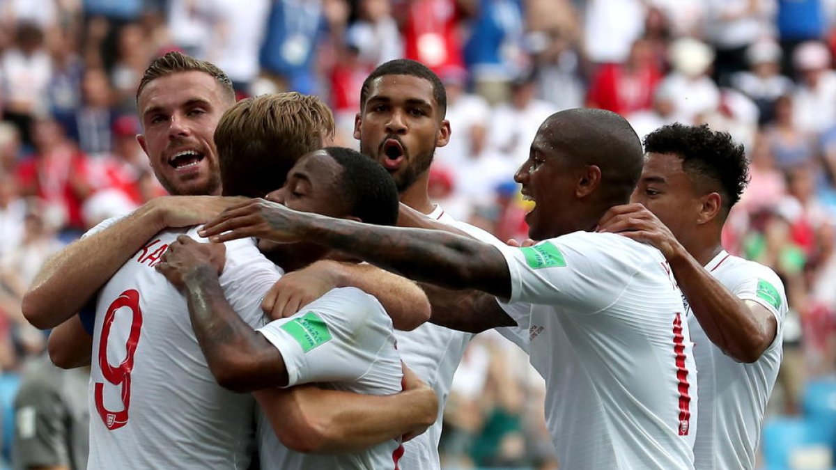 Harry Kane és felicitat pels companys després d’anotar de penal el cinquè gol del seu equip abans del descans.