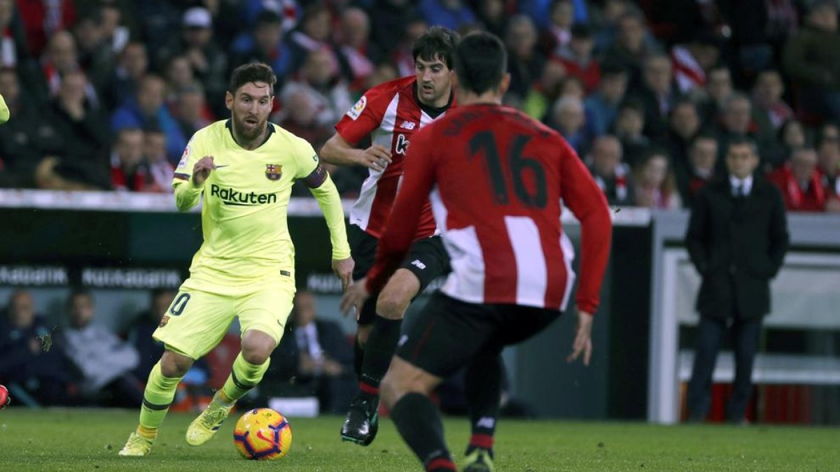 Messi, en una acció assetjat per dos rivals.