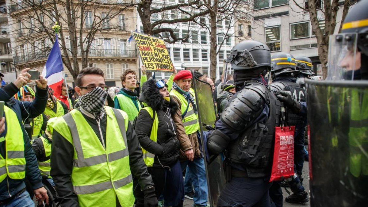 Membres dels Armilles Grogues, ahir, davant de les forces de l’ordre als carrers de París.