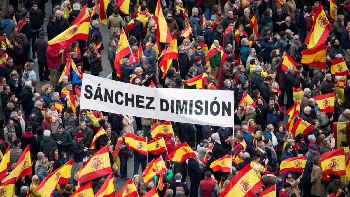 Manifestants amb una pancarta en la qual es demanava la dimissió de Pedro Sánchez.