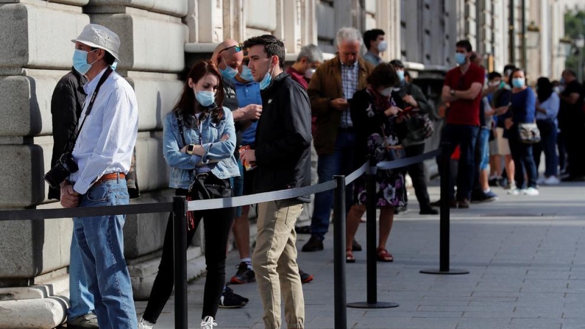 Un grupo de personas hace cola para visitar el Palacio Real en Madrid, que reabrió sus puertas ayer.