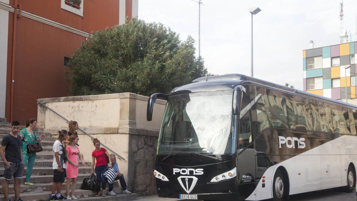 Algunos de los pasajeros afectados en la estación de Tàrrega a punto de subir a un autobús.