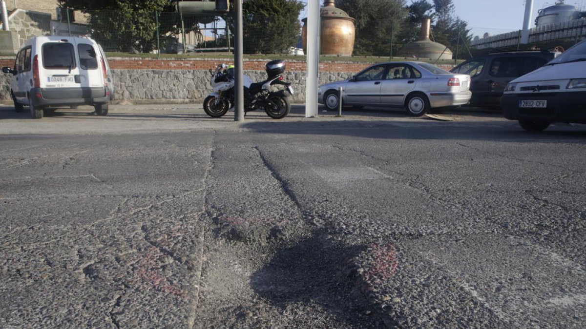 Socavones de grandes dimensiones - El pavimento del vial principal del polígono El Segre se encuentra en un estado pésimo, con numerosos socavones de grandes dimensiones, como los de las imágenes, que están señalados con una línea roja. Los ...