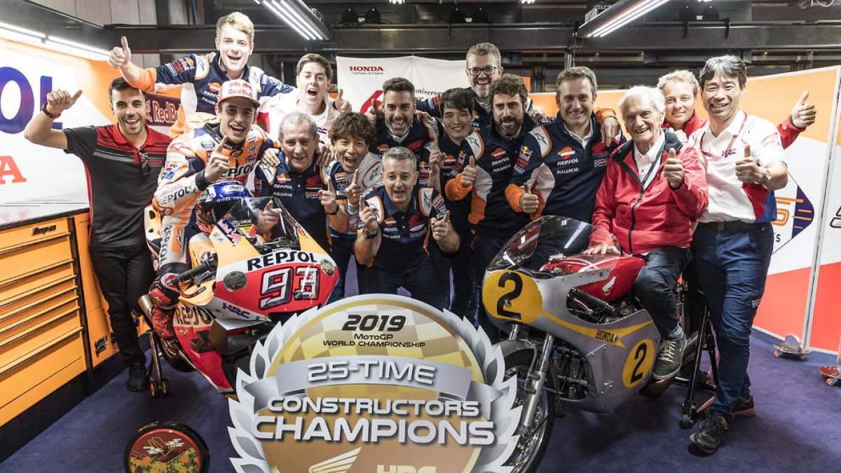 Marc Màrquez y todo su equipo, junto al excampeon mundial Jim Redman, a lomos de la moto que pilotó en su época, festejan el título mundial de constructores que dieron a Honda, precisamente en su circuito.