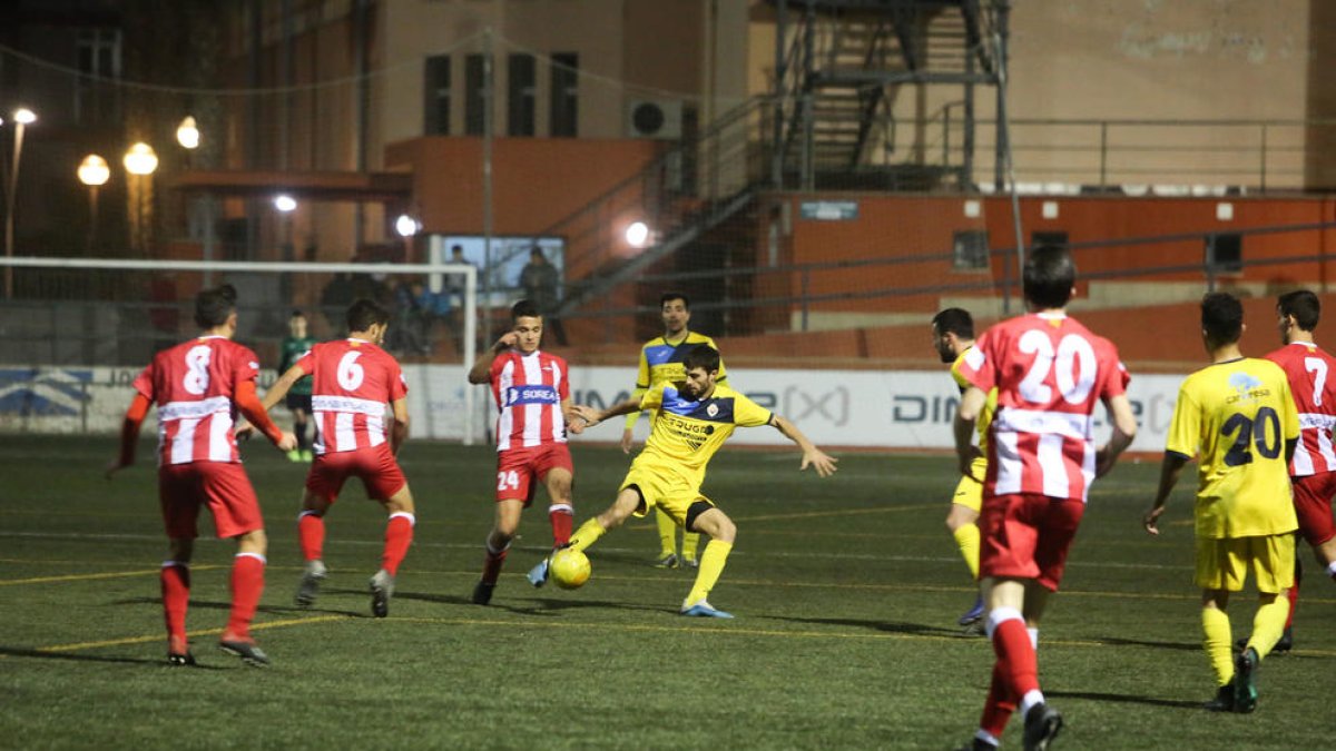 Un jugador del Tàrrega pugna por el balón ayer ante varios jugadores del Valls.