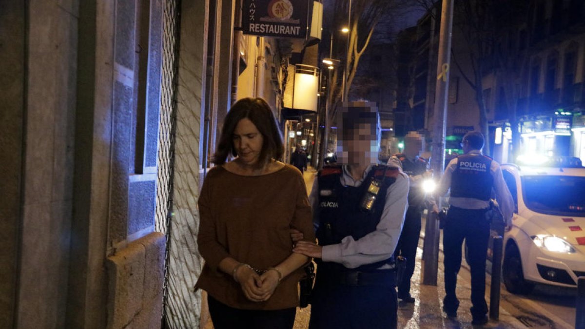 Una agente de los Mossos d’Esquadra se lleva esposada a la mujer que ha ahogado a su hija de 10 años
