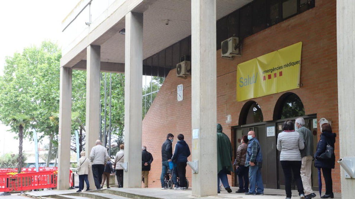 Persones fent cua al pavelló Onze de Setembre, un dels centres de vacunació.