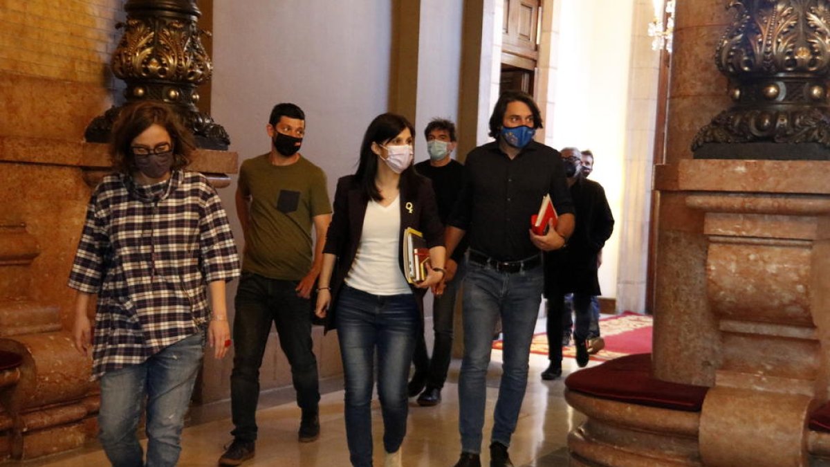 Els negociadors de la CUP, ERC i JxCat sortint de la reunió a tres bandes.