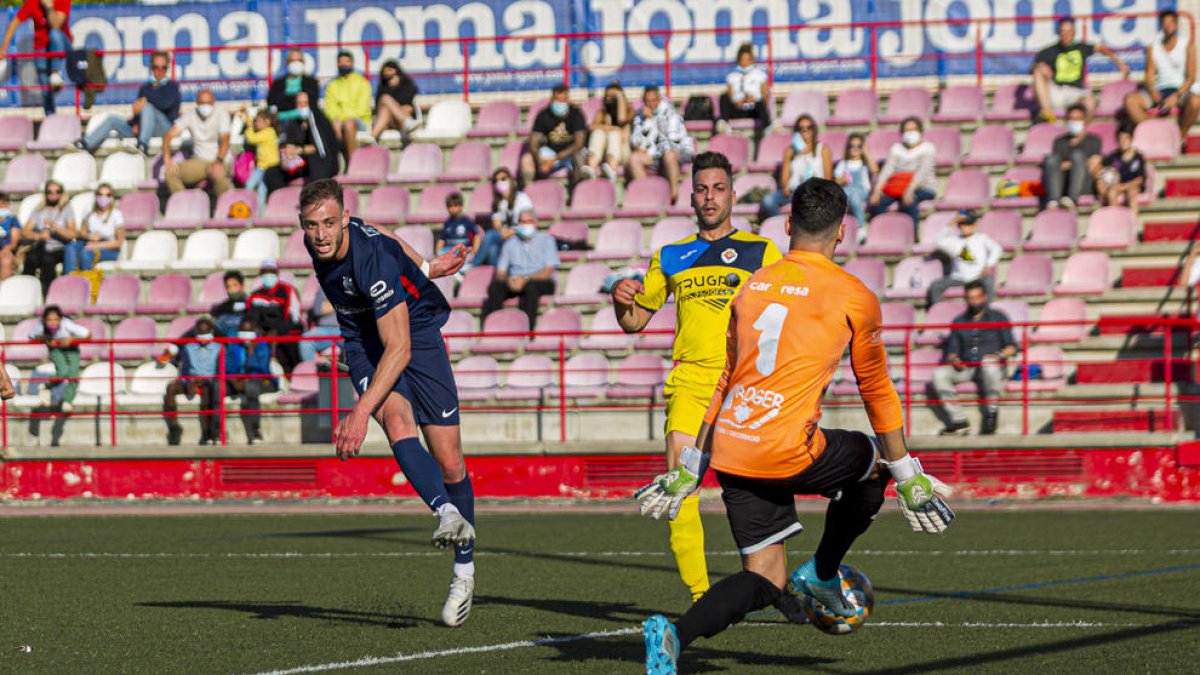 Dani Vargas, de l’Atlètic Lleida, intenta batre Albert Alfonso, que evita el gol amb el peu.