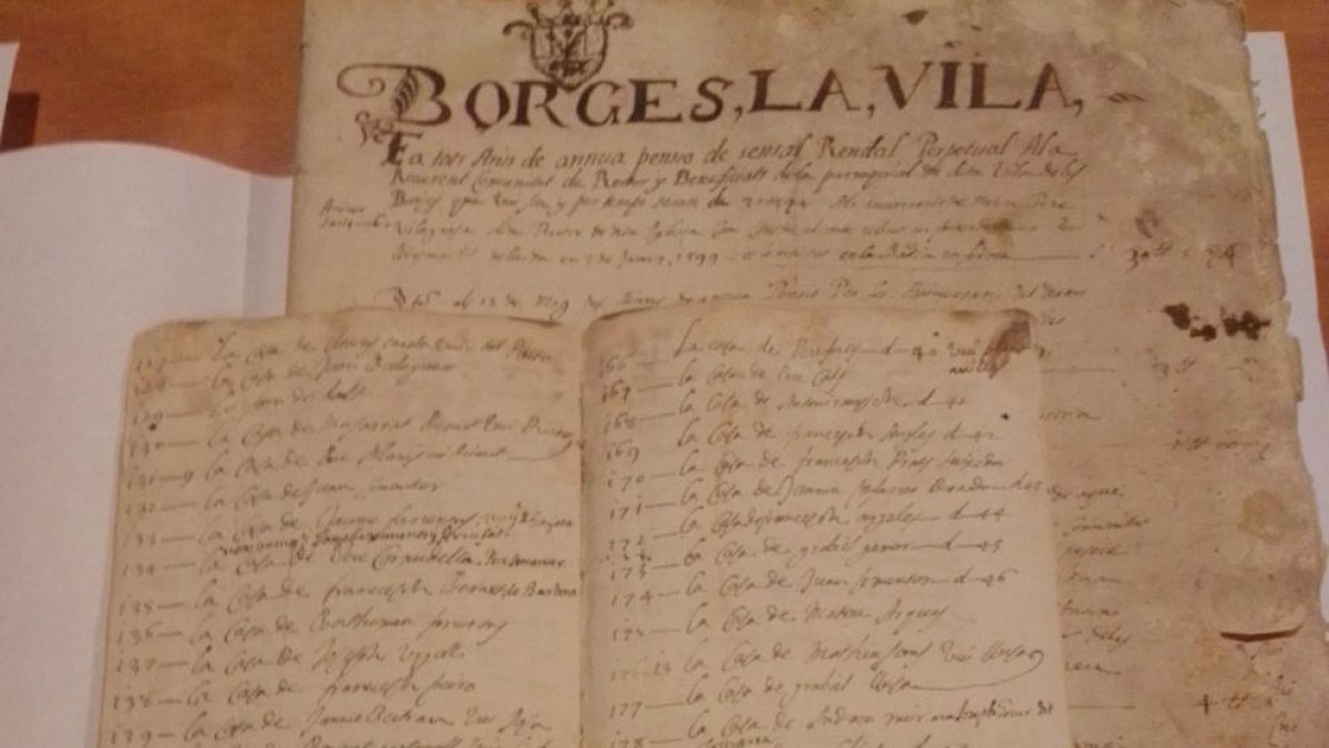 A la derecha, Josep Segura con la documentación de Eduard Mias en el Espai Macià, entre ella un censo del XVII (arriba).