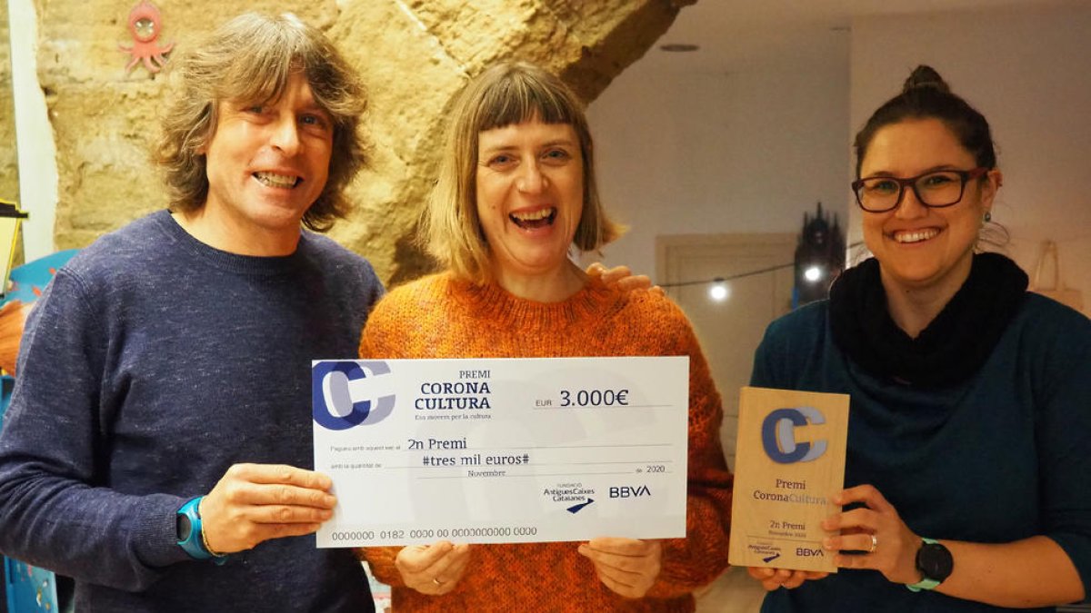 Mertxe París (centre), a la llibreria El Genet Blau amb el ‘xec’.