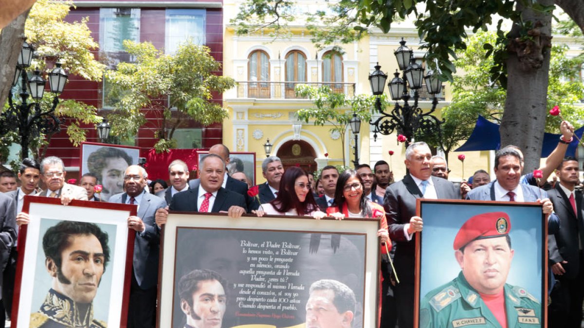 Representantes chavistas, como la mujer de Maduro, portan retratos de Hugo Chávez y Simón Bolívar.