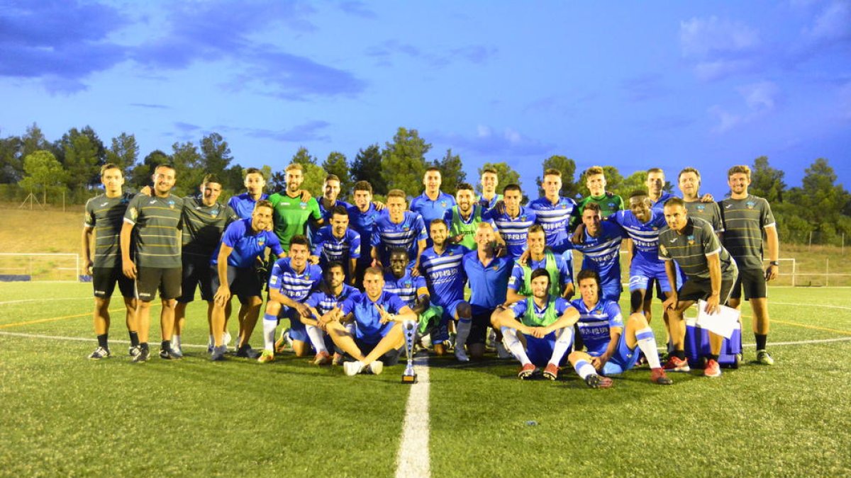 La plantilla y técnicos del Lleida Esportiu posan con el trofeo conquistado ayer en Santboià.