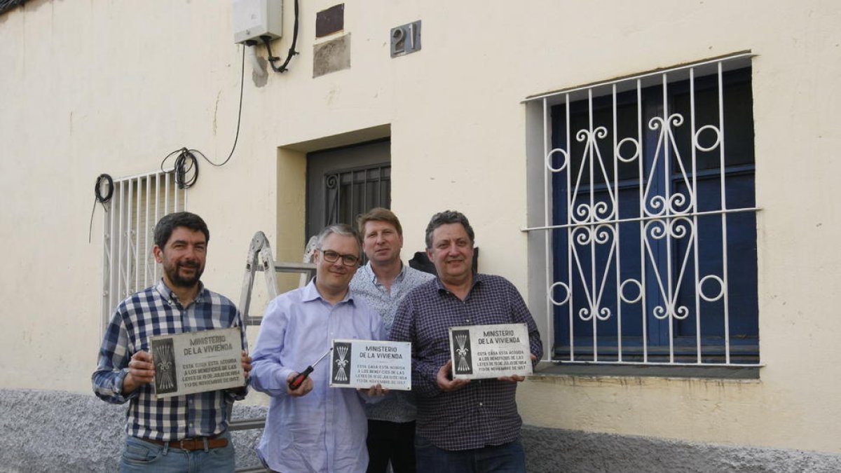 Los representantes de esta firma muestran las tres placas con el símbolo falangista que han retirado.