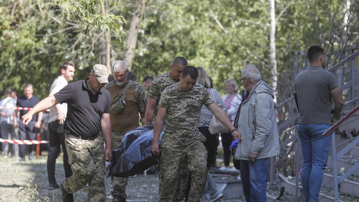 Els equips de rescat traslladen el cos d’una víctima a Kíiv.