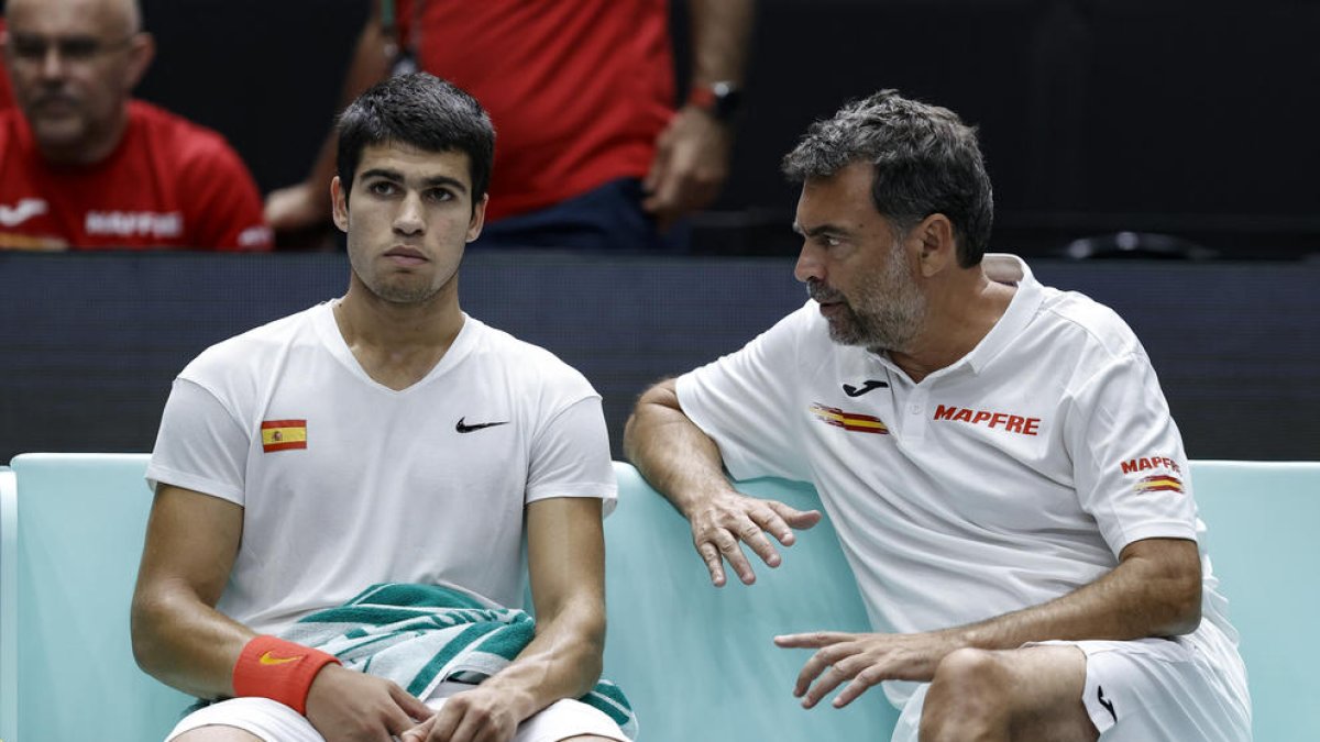 Alcaraz, con rostro serio, recibe consejos del capitán Sergi Bruguera.