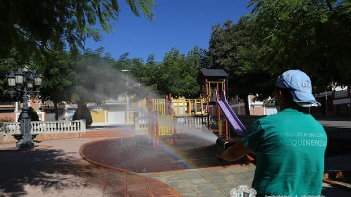 Un empleado de la brigada limpiando un parque infantil.